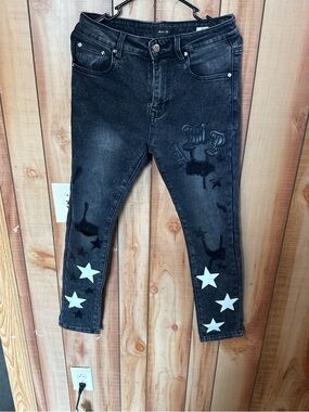 AMIRI Black Washed Skinny Jeans with White Star Accents